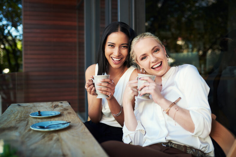 Portrait, coffee and friends in cafe, smile and bonding of women, laughing and happy to relax in weekend. Customer, enjoy and girls with beverage for conversation, morning and break for students.