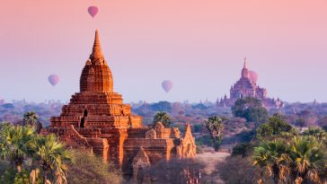 Hot air balloon over misty morning around Temple in Bagan , Myanmar