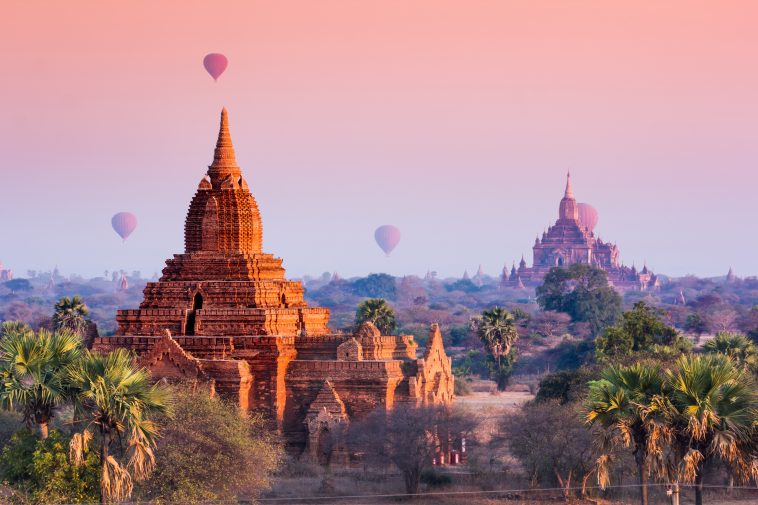 Hot air balloon over misty morning around Temple in Bagan , Myanmar