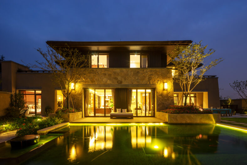 facade of modern building near pond in clear sky at night