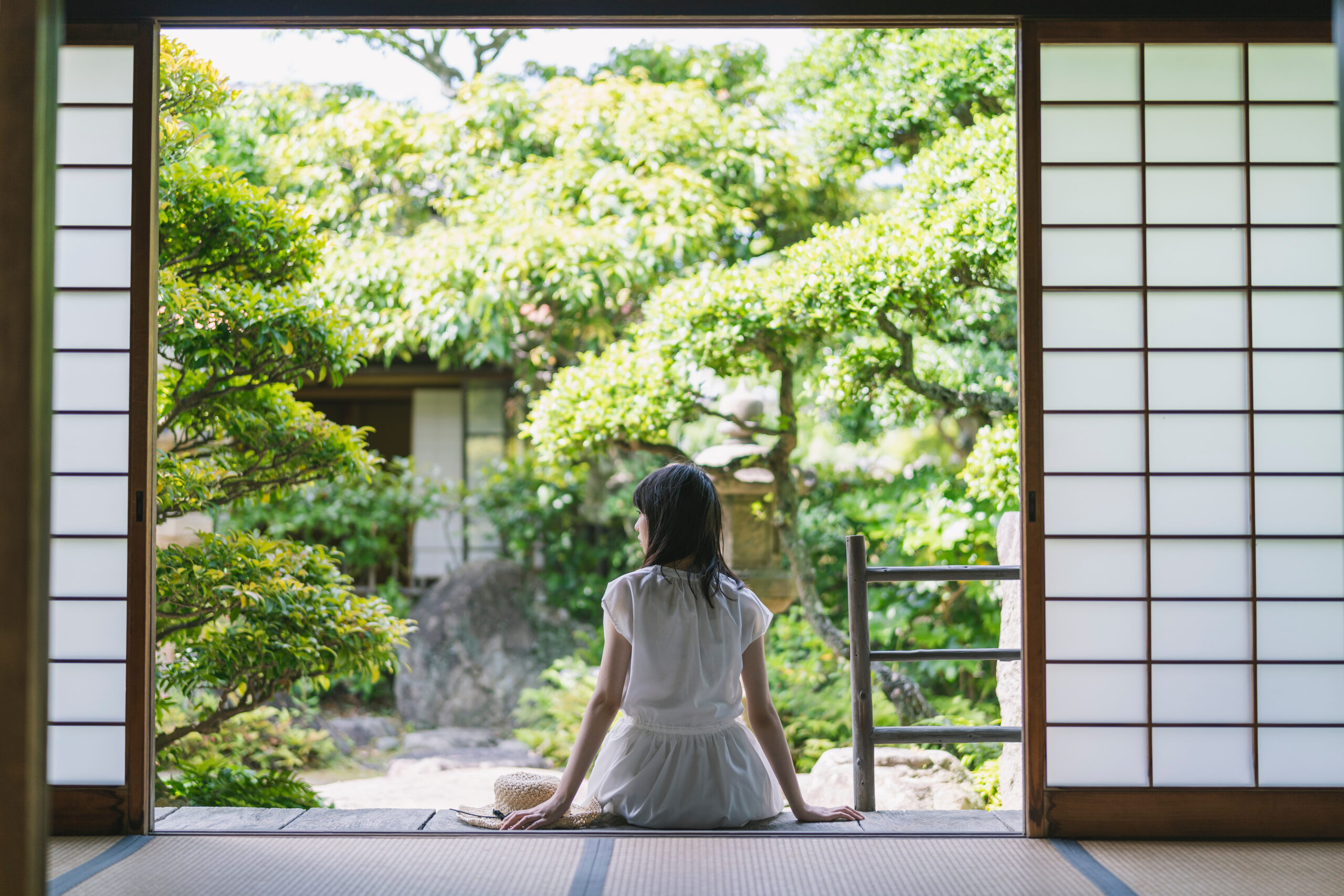 young woman in front of trees