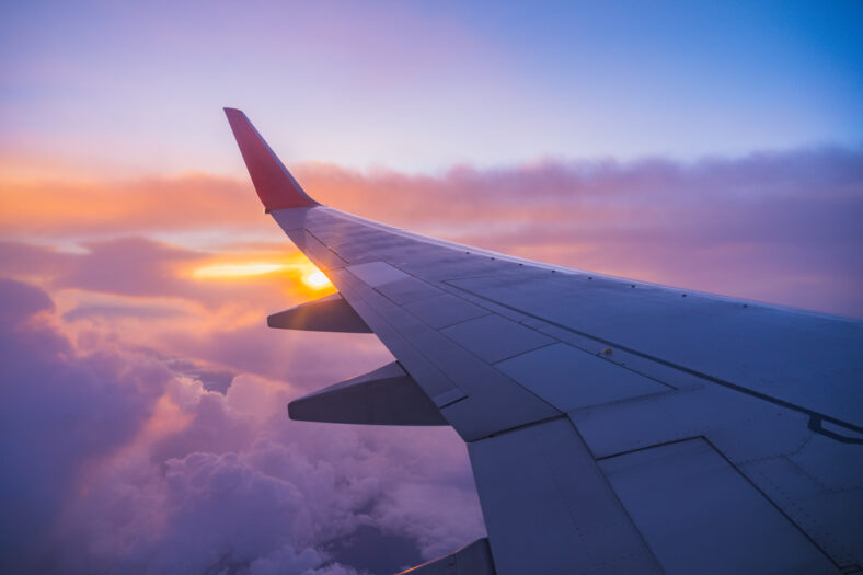 Beautiful sunset, sky on the top view, airplane flying view from inside window aircraft of Traveling.