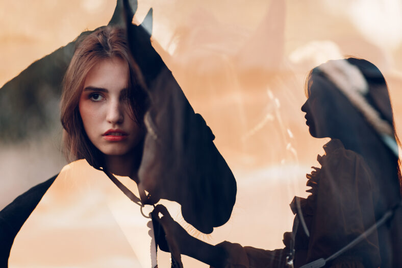 Woman silhouette with her horse at outdoors ranch