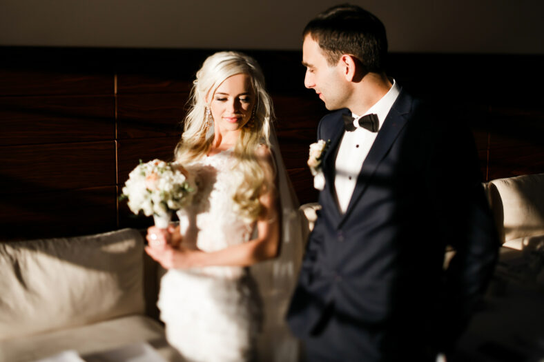 gently blonde bride and solid groom in resturant