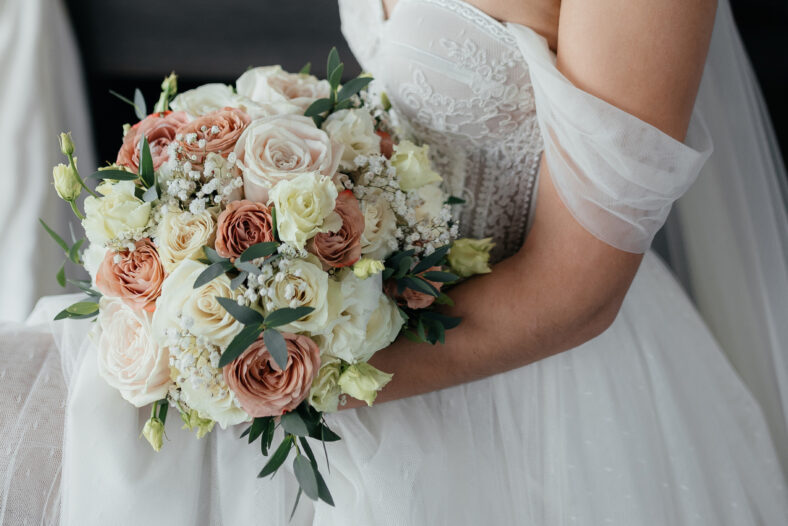 Bride's bouquet close up, the bouquet consists of pink and white roses. The bride holds a bouquet. High quality photo