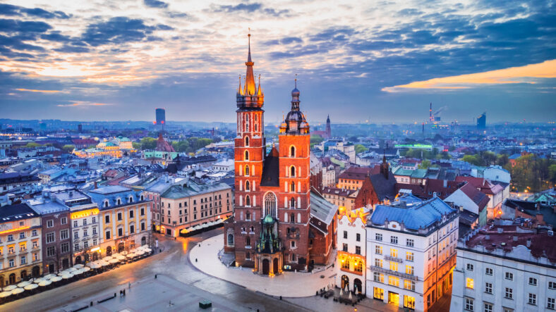 Krakow, Poland. Bazylika Mariacka church and Cloth Hall on Main Square Cracovia, illuminated in the night