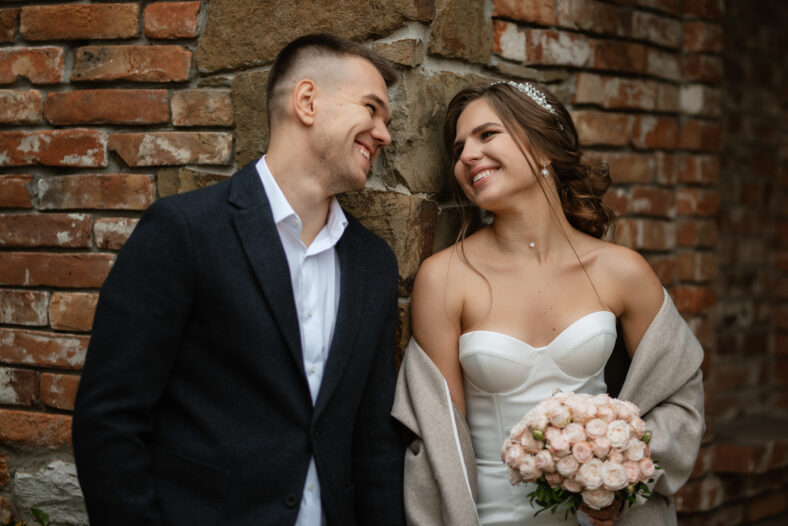 portrait of a young couple of bride and groom on their wedding day in a country cottage