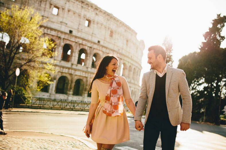 Young couple on the background of the Colosseum, Rome, Italy