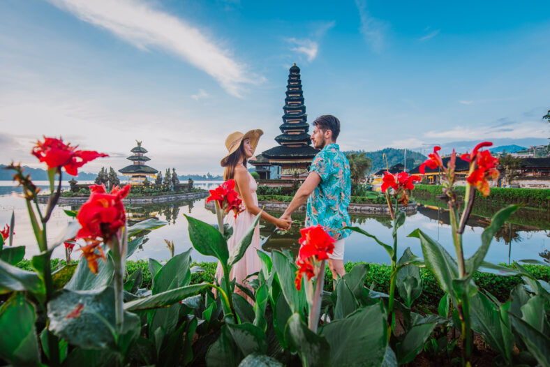 Couple spending time at the ulun datu bratan temple in Bali. Concept about exotic lifestyle wanderlust traveling