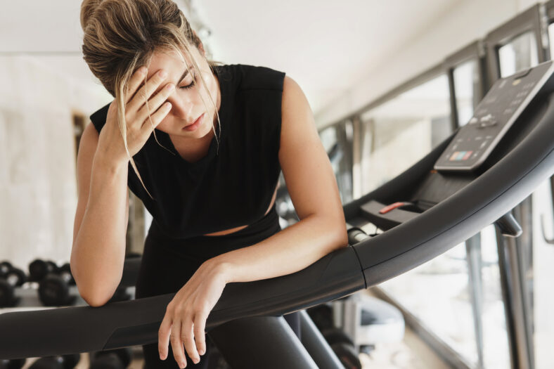 Exhausted athletic woman after her fitness workout in the gym