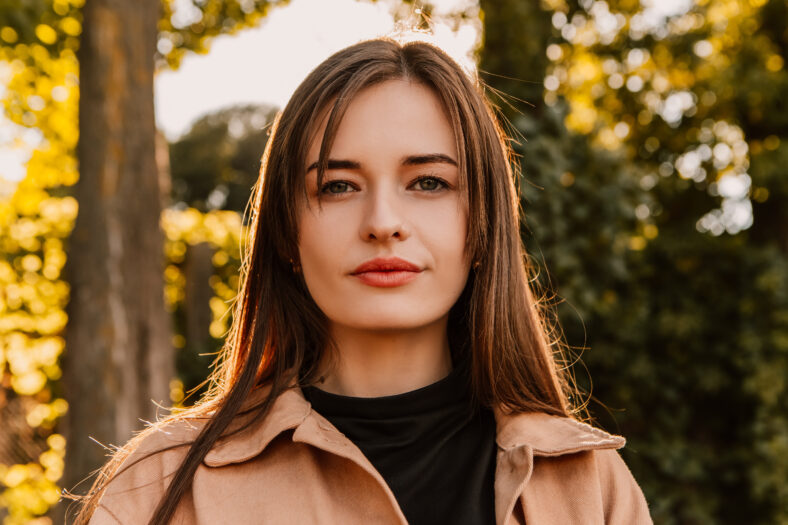 young woman wearing a trench coat outside