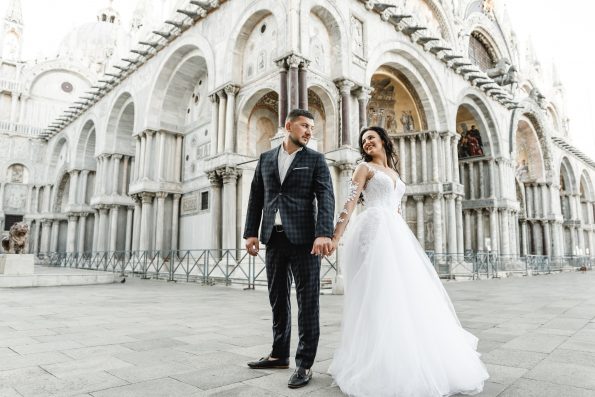 bride and groom on the background of a historic building,bride and groom walk the streets of the old city of venice,newlyweds dance,european wedding